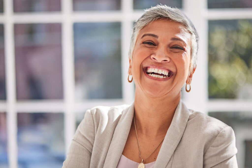 Adult patient smiling confidently after restorative dental treatment